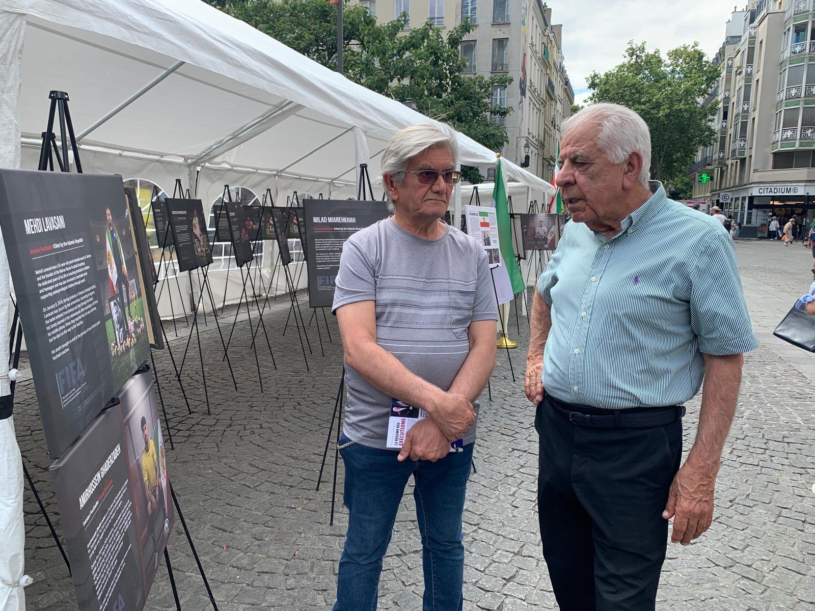 Échanges entre visiteurs devant les portraits — Beaubourg et Les Halles en toile de fond.
